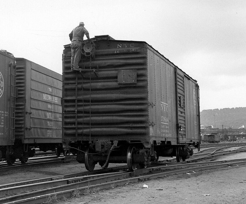 Photo of D&H Switchman riding box car in 1958